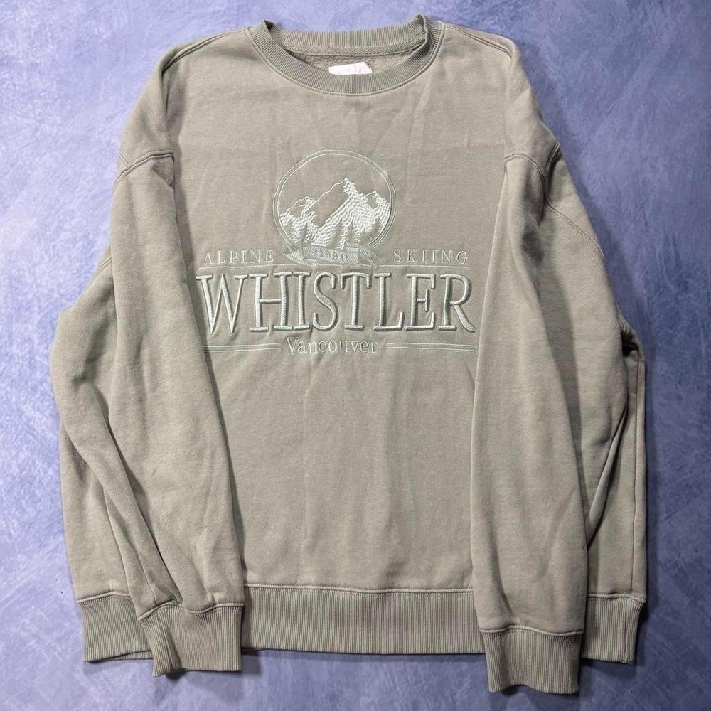 light green crewneck with forest details.